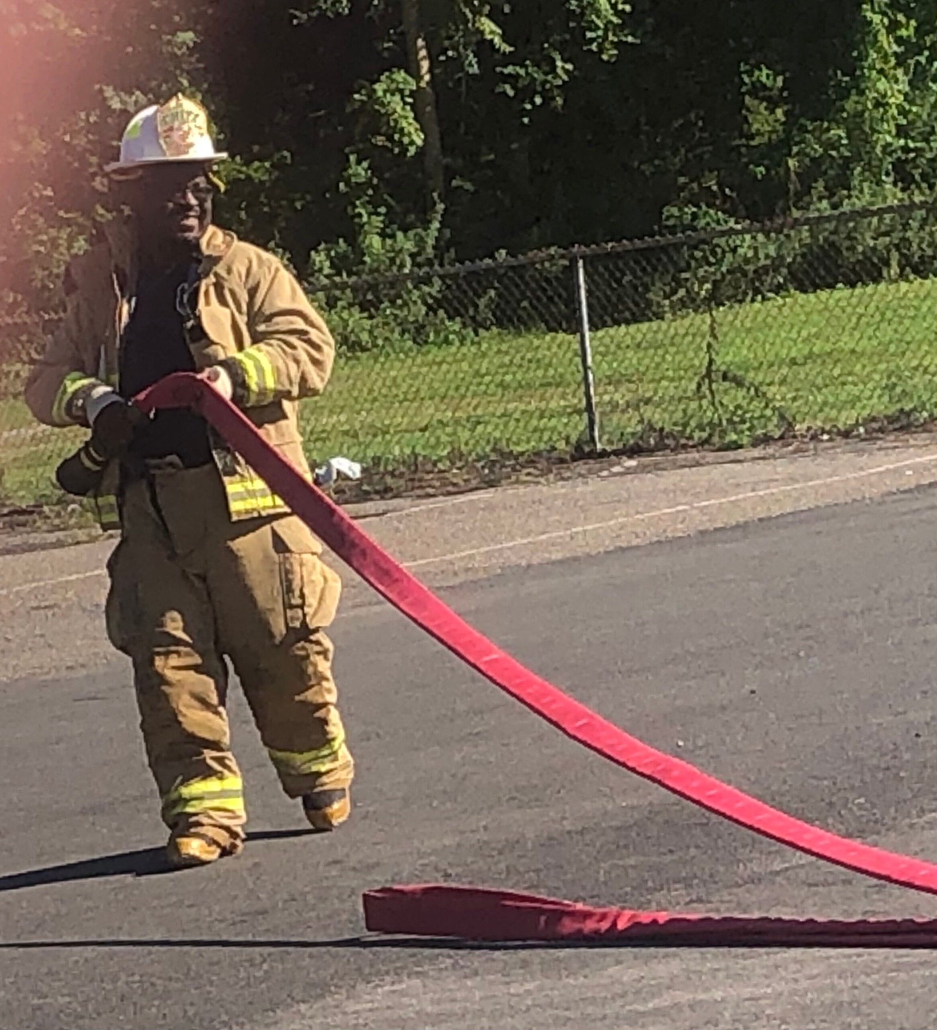 Chief Eugene W. Johnson Jr. in firefighting protective gear during hose-line operations